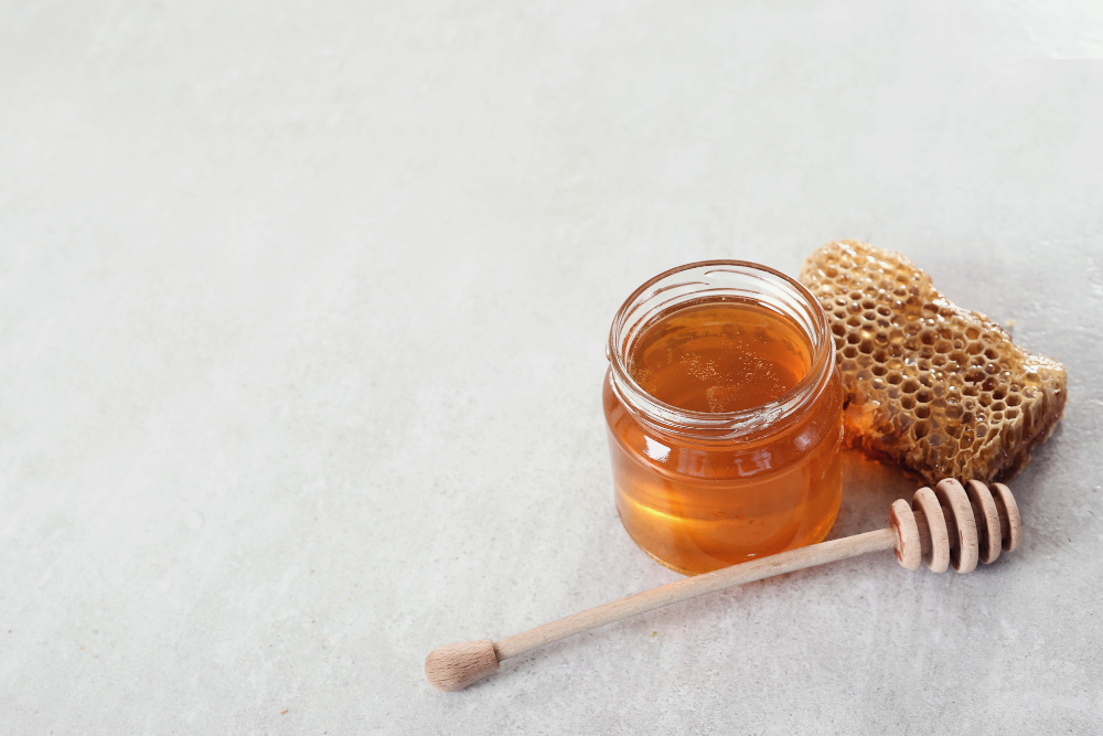 Jar of honey with honeycomb